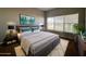 Comfortable bedroom featuring a queen bed, plush rug, and bright natural light from the large windows at 340 Cimarron Ct, Poinciana, FL 34759
