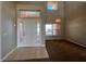 A spacious entryway with a light-colored front door, neutral paint, tile flooring, and transom windows at 340 Cimarron Ct, Poinciana, FL 34759