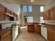 Bright kitchen featuring light wood cabinets, tile flooring and a mountain view out of the large windows at 340 Cimarron Ct, Poinciana, FL 34759