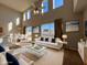 Bright and airy living room with neutral tones, modern furnishings, and ample natural light at 340 Cimarron Ct, Poinciana, FL 34759