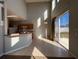 Open living space with light tile flooring, kitchen bar seating, sliding glass doors and tall ceilings at 340 Cimarron Ct, Poinciana, FL 34759