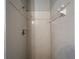 Shower stall featuring white tile, soap dish, and shower head at 340 Cimarron Ct, Poinciana, FL 34759