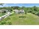 Aerial view of a white, single-story home featuring a spacious, well-maintained lawn with mature trees at 3440 La Salle Ave, St Cloud, FL 34772