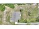 Aerial view showcasing the home's layout, roofing, driveway, and surrounding landscape at 3440 La Salle Ave, St Cloud, FL 34772