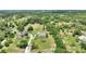 Aerial view shows the home surrounded by lush landscape and mature trees providing privacy and a serene setting at 3440 La Salle Ave, St Cloud, FL 34772