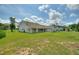 A view of a large home with a covered patio and a green backyard at 3440 La Salle Ave, St Cloud, FL 34772
