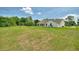 A white home with a green backyard and a wire fence at 3440 La Salle Ave, St Cloud, FL 34772