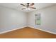This bedroom features wood floors, a ceiling fan, and natural light at 3440 La Salle Ave, St Cloud, FL 34772