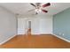 This bedroom features wood floors, a ceiling fan, and closet storage at 3440 La Salle Ave, St Cloud, FL 34772