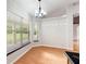 Bright dining area features wood floors, modern chandelier, and large windows with views of the outdoors at 3440 La Salle Ave, St Cloud, FL 34772
