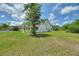 Charming one-story home featuring a cozy front porch and a spacious, well-maintained lawn with mature tree at 3440 La Salle Ave, St Cloud, FL 34772