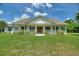Charming single-story home with a welcoming front porch, green shutters, and well-manicured landscaping at 3440 La Salle Ave, St Cloud, FL 34772