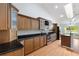 Bright kitchen with stainless steel appliances, wood cabinets, granite countertops, and a view of the outdoor scenery at 3440 La Salle Ave, St Cloud, FL 34772