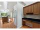 Kitchen with custom desk, pantry and view into living spaces with natural light and open layout design at 3440 La Salle Ave, St Cloud, FL 34772