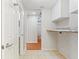 Bright laundry area features tile flooring, washer/dryer hookups and door to adjacent powder room at 3440 La Salle Ave, St Cloud, FL 34772