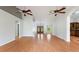 Open living room with wood-look flooring and view of the entryway with double doors and large windows at 3440 La Salle Ave, St Cloud, FL 34772