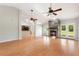 Large living room with a stone fireplace, wood-look flooring, and plenty of natural light from French doors and skylights at 3440 La Salle Ave, St Cloud, FL 34772