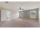 Spacious main bedroom with ceiling fan, carpet, two windows, and en-suite bathroom at 3440 La Salle Ave, St Cloud, FL 34772