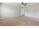 Spacious main bedroom with ceiling fan, carpet, and view to en-suite bathroom at 3440 La Salle Ave, St Cloud, FL 34772