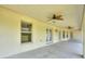 Spacious covered patio with dual ceiling fans and multiple access points to the lush outdoor space at 3440 La Salle Ave, St Cloud, FL 34772