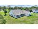 Spacious backyard featuring a covered patio, lush lawn, and secure fencing for privacy and outdoor enjoyment at 3440 La Salle Ave, St Cloud, FL 34772