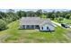 Aerial view showcasing the home's backyard with a covered patio and a large, fenced-in lawn at 3440 La Salle Ave, St Cloud, FL 34772