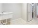 Functional utility sink area with tile flooring, white sink basin, and door to adjacent powder room at 3440 La Salle Ave, St Cloud, FL 34772