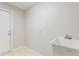 Functional utility sink area with tile flooring, white sink basin, and adjacent exterior door at 3440 La Salle Ave, St Cloud, FL 34772