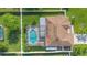 Birds eye view of a property with a pool, patio, fenced yard, and brown shingle roof at 454 Eagle Dr, Kissimmee, FL 34759