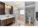 Bathroom with shower, toilet, vanity, mirror, and tile floors at 454 Eagle Dr, Kissimmee, FL 34759