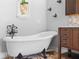 Bright bathroom featuring a freestanding tub and a custom vanity with decorative tile backsplash at 454 Eagle Dr, Kissimmee, FL 34759
