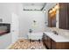 Elegant bathroom featuring a freestanding tub, custom vanity, and decorative tile flooring at 454 Eagle Dr, Kissimmee, FL 34759
