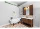 Elegant bathroom featuring a freestanding tub, custom vanity, and decorative tile flooring at 454 Eagle Dr, Kissimmee, FL 34759