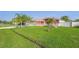 Charming single-story home with a well-manicured lawn, a white picket fence, and decorative palm trees at 454 Eagle Dr, Kissimmee, FL 34759