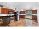 Bright kitchen with wooden cabinets and stainless steel appliances at 454 Eagle Dr, Kissimmee, FL 34759