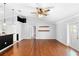 Spacious living room featuring hardwood floors and an open layout with a view of the kitchen at 454 Eagle Dr, Kissimmee, FL 34759