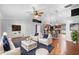 Staged living room with hardwood floors open to a modern kitchen with stainless steel appliances at 454 Eagle Dr, Kissimmee, FL 34759