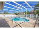Enclosed pool area with a paver patio and a clear blue in-ground pool, with a secure screen enclosure at 454 Eagle Dr, Kissimmee, FL 34759