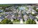 An aerial view of a subdivision showing houses with pools surrounding a small lake at 4707 Pershoie Ln, Kissimmee, FL 34746