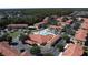 Aerial view of the community showcasing pool, lush landscaping, and plenty of parking at 4707 Pershoie Ln, Kissimmee, FL 34746