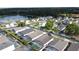 Wide aerial view of a quiet residential neighborhood and lake, each home has a screened in pool at 4707 Pershoie Ln, Kissimmee, FL 34746