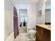 Standard bathroom featuring a shower-tub combination, single sink vanity, and a view into the bedroom at 4707 Pershoie Ln, Kissimmee, FL 34746