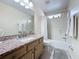 Standard bathroom with a large vanity, an over-sized mirror, a shower-tub combination, and tile floors at 4707 Pershoie Ln, Kissimmee, FL 34746