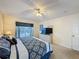 Bedroom with a queen bed, dresser with TV, and door leading to other parts of the house at 4707 Pershoie Ln, Kissimmee, FL 34746