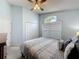 Cozy bedroom featuring a queen bed, ceiling fan, and a window with blinds at 4707 Pershoie Ln, Kissimmee, FL 34746