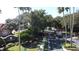 Gated community entrance with lush landscaping and mature trees at 4707 Pershoie Ln, Kissimmee, FL 34746