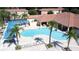Inviting community pool and deck area featuring lounge chairs, cabanas, and lush landscaping at 4707 Pershoie Ln, Kissimmee, FL 34746