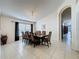 Elegant dining room with a large table, stylish chairs, and tile flooring at 4707 Pershoie Ln, Kissimmee, FL 34746