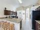 Bright kitchen featuring granite countertops and dark wood cabinetry at 4707 Pershoie Ln, Kissimmee, FL 34746