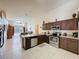 Open kitchen layout featuring granite countertops, stainless steel appliances, and views of the living area and pool at 4707 Pershoie Ln, Kissimmee, FL 34746